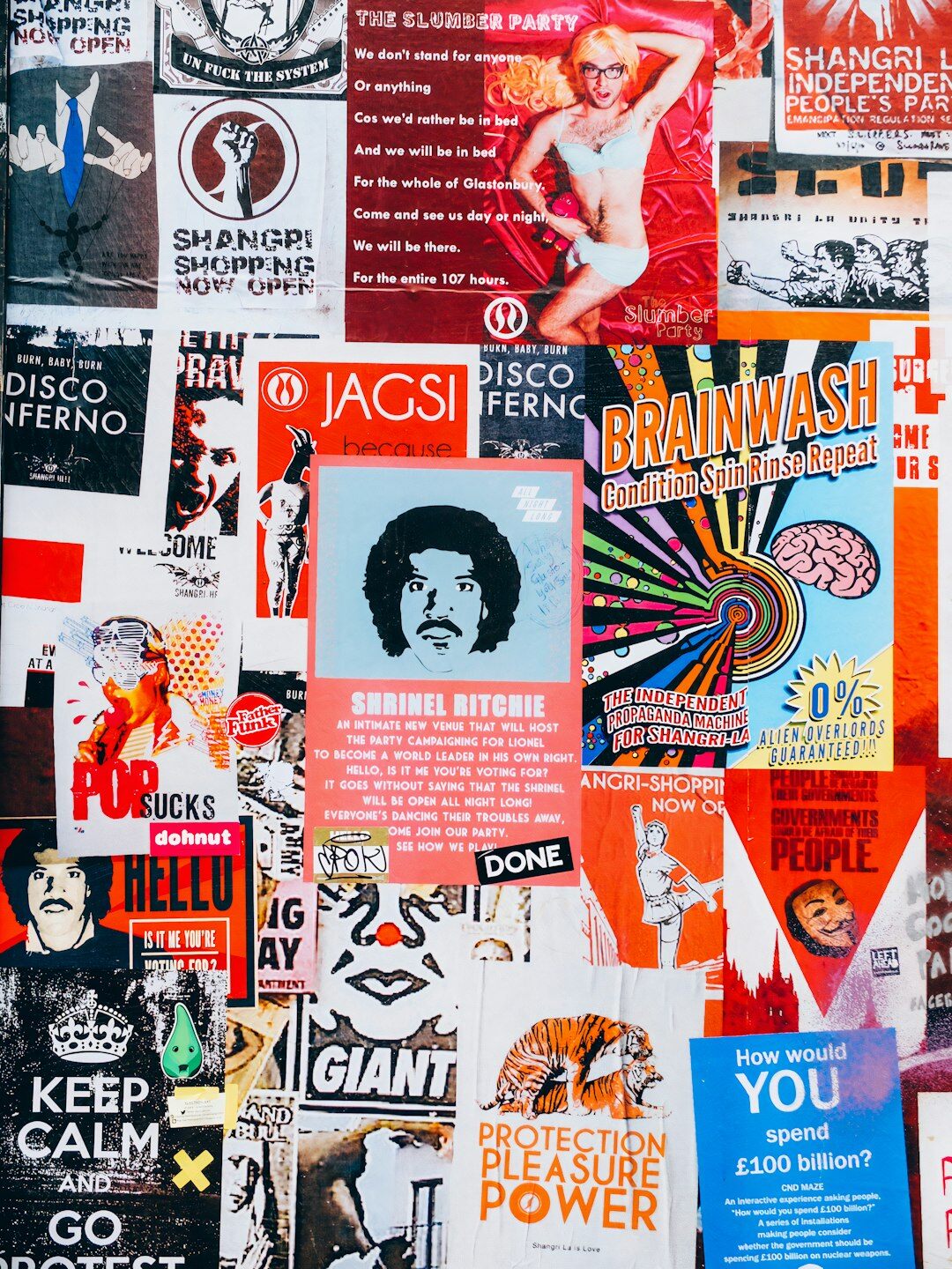 Stack of vintage advertising posters and print magazines